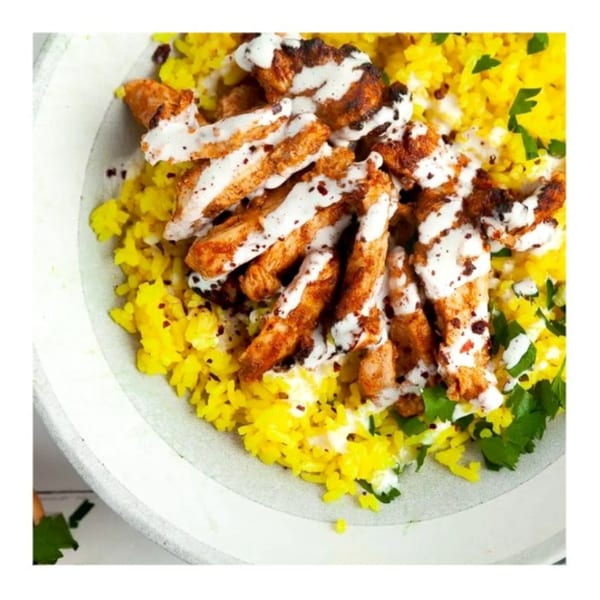 Zait & Za'atar's chicken shawarma with yellow rice, white sauce, and fresh parsley.