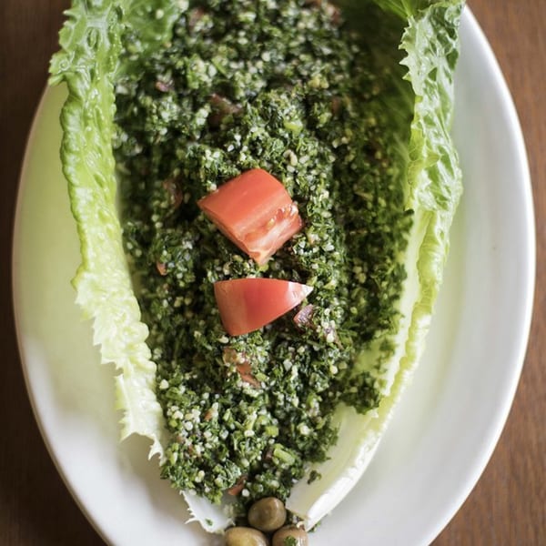 A close-up of Zait & Za'atar's tabbouleh salad with fresh parsley, tomatoes, and bulgur.